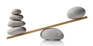 Smooth stones balancing on a seesaw, showing how a strategic planning timeline is about balancing agility and vision.