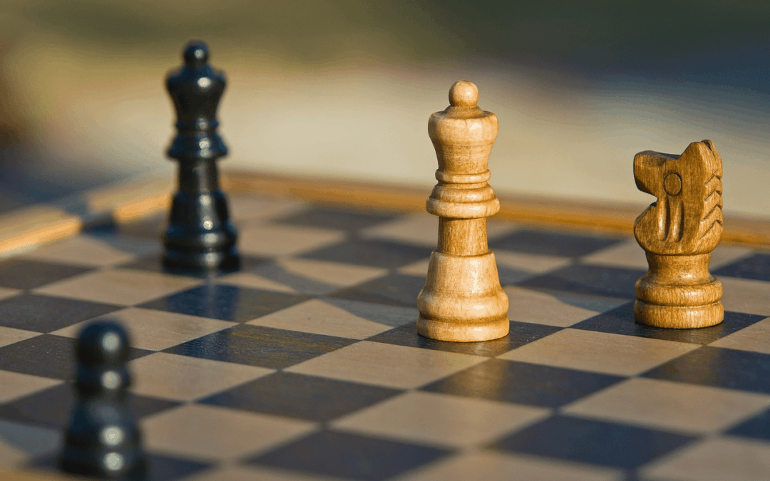 A chessboard with two white pieces and two black pieces, showing how integrating risk management into strategic planning can strengthen an organization.
