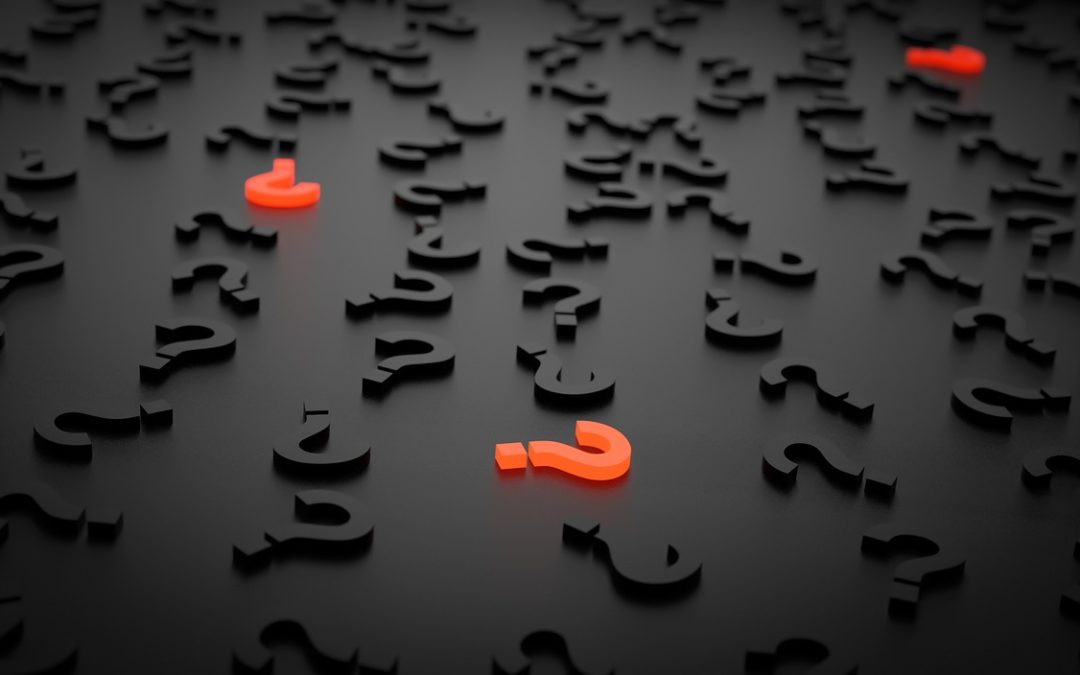 Black letters on a black background with red question marks, illustrating the question of why to hire a consultant for strategic planning.