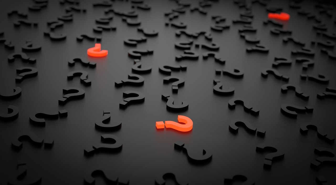 Black letters on a black background with red question marks, illustrating the question of why to hire a consultant for strategic planning.