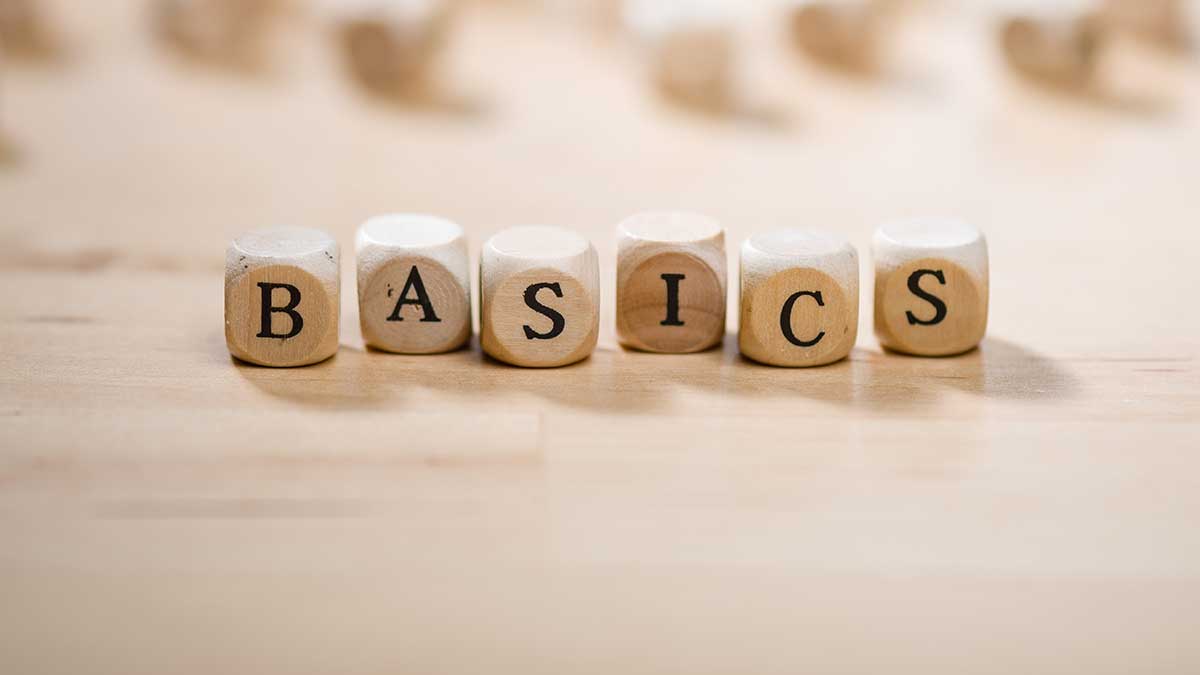 Wooden blocks on a tabletop spelling out the word basics, demonstrating the value of understanding the basics of different strategic planning models.